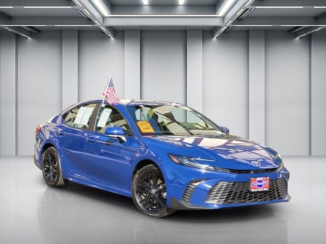 2025 Toyota Camry LE in Reservoir Blue — front three-quarter view